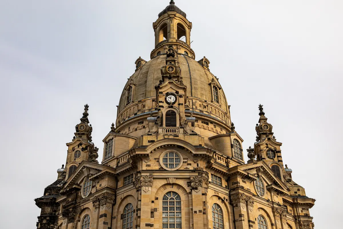 Den stensatte kuppel på Frauenkirche i Dresden med et forgyldt kors og fire små hjørnetårne.